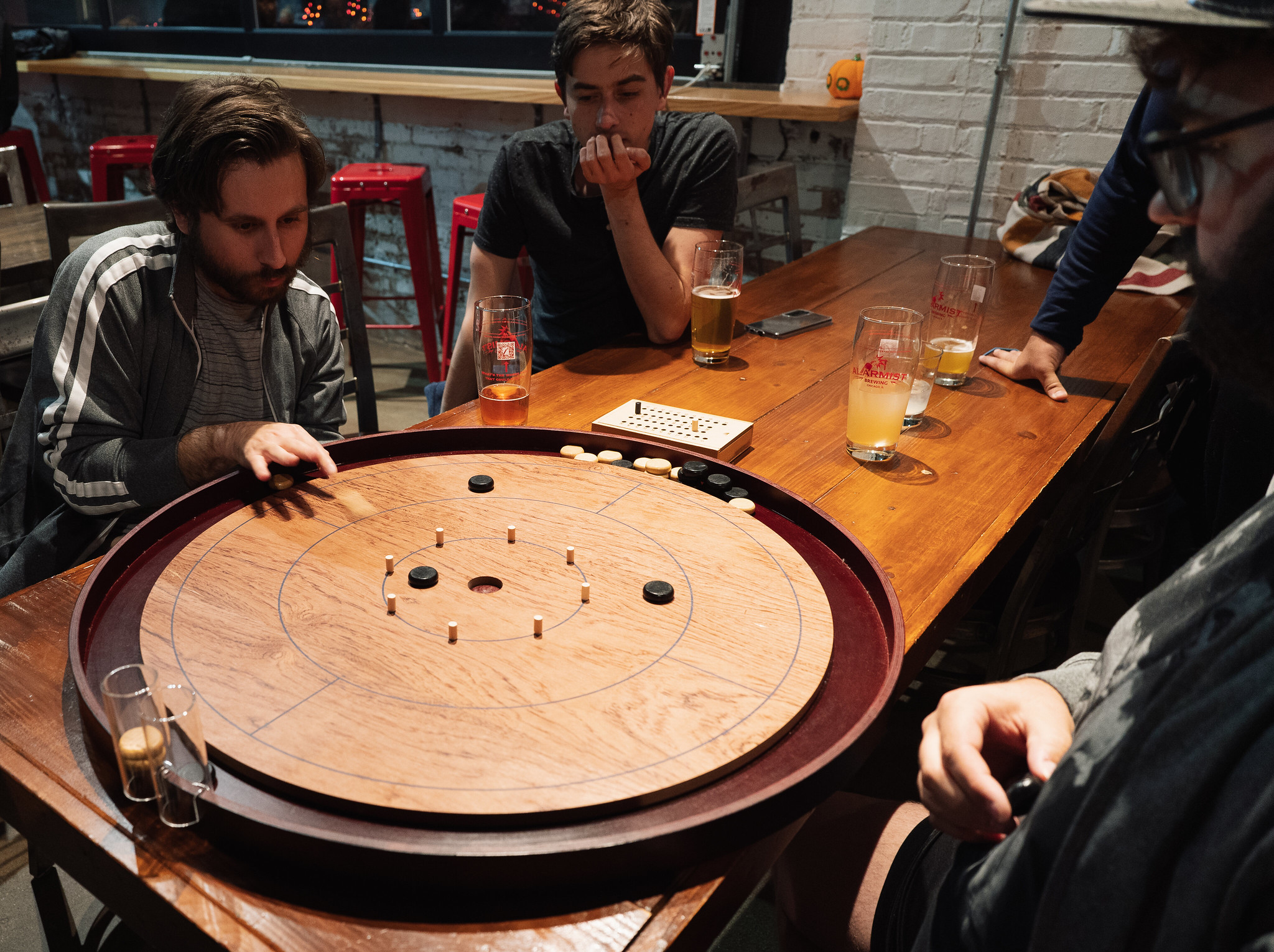 People playing crokinole